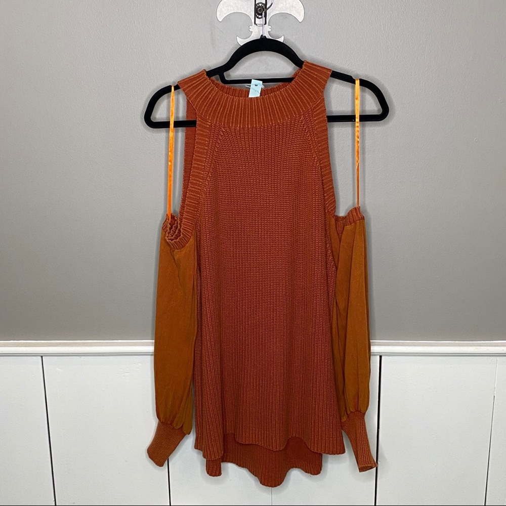 Sweater with shoulder cut out.